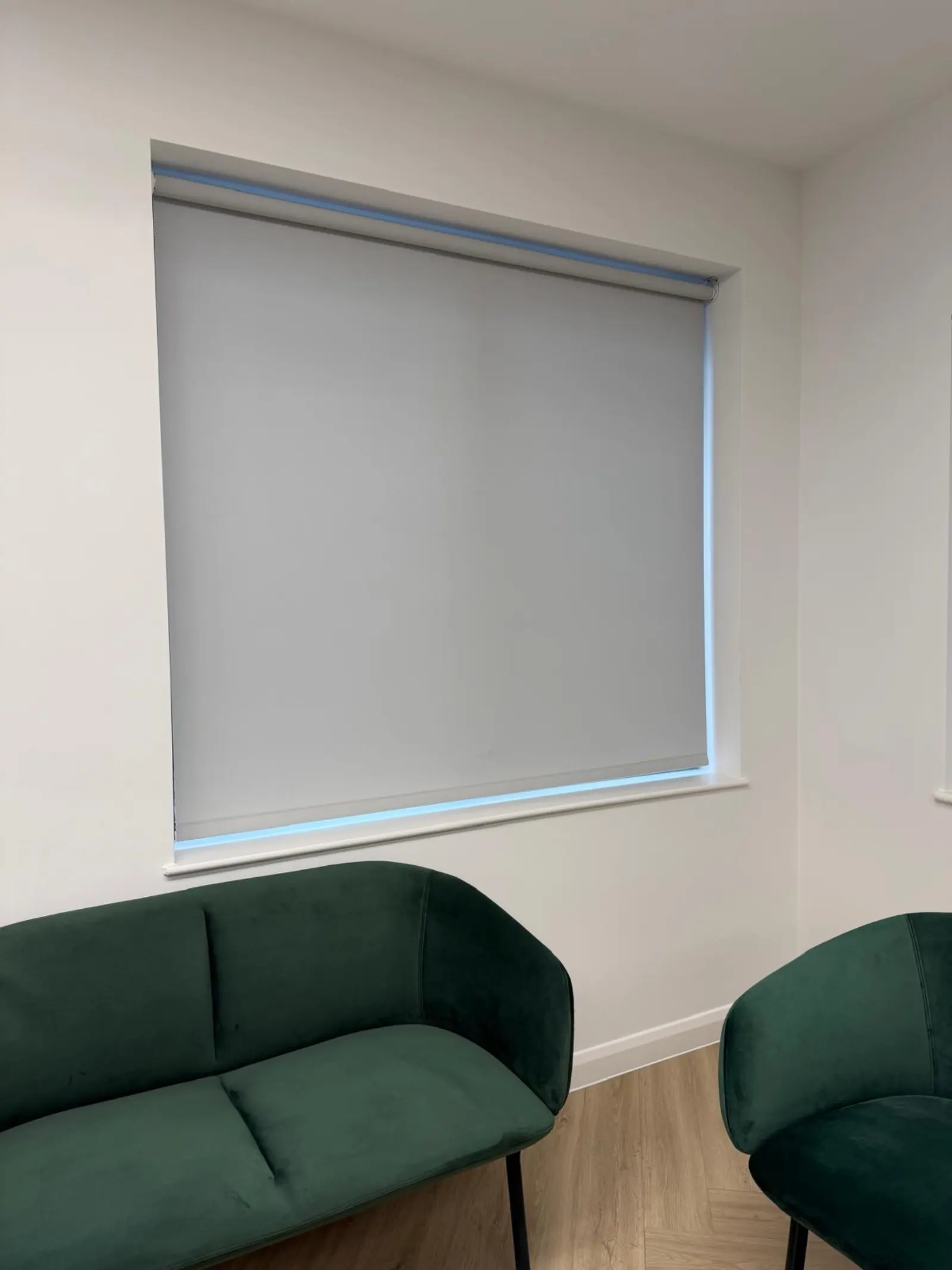 Grey roller blinds fitted in an office waiting area